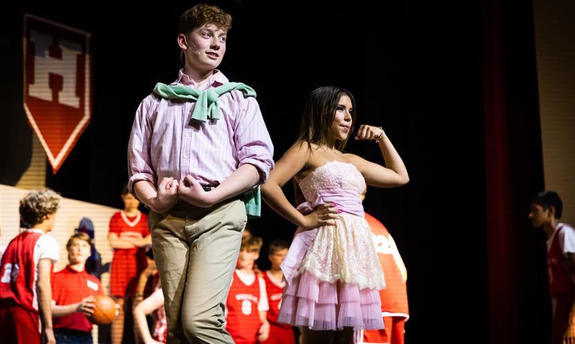Two students, playing Ryan and Sharpay Evans, dance onstage